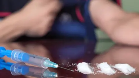 Heroin syringe needle with cocaine .